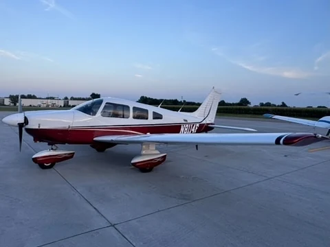 Piper Archer II N8114F shown broadside on an apron beneath a soft evening sky