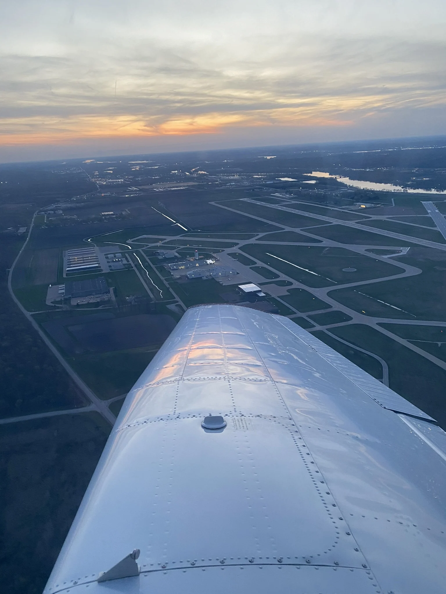 Sunset aerial view over Quad Cities International Airport from the wing of a club aircraft