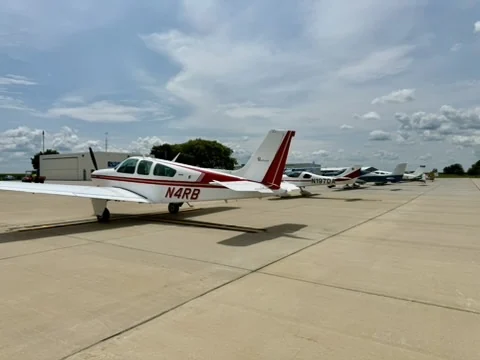 Beechcraft Bonanza N4RB with other aircraft parked in the background